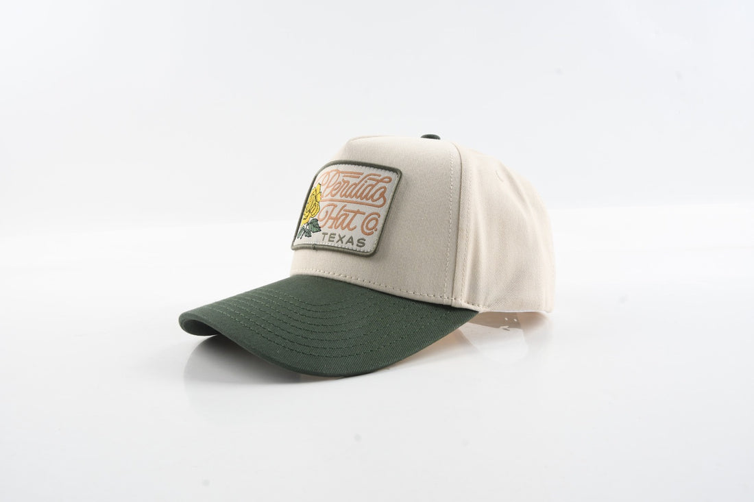 Front view of The Emily hat with green brim and yellow rose woven patch.