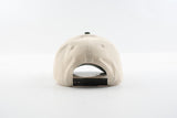 Back view of The Emily hat showing tan cotton panels and dark snapback closure.