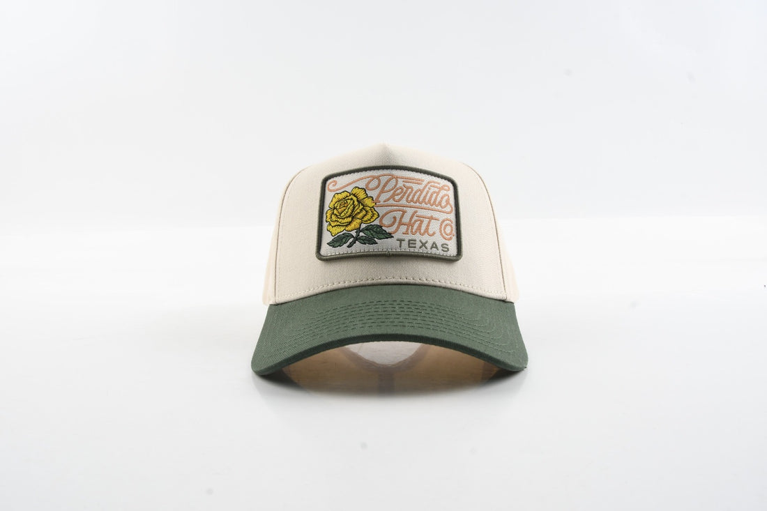 Front view of The Emily hat with green brim and yellow rose woven patch.