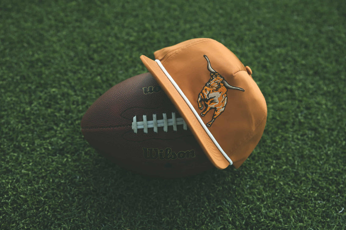 Brown cap with a logo on a football on a grassy field