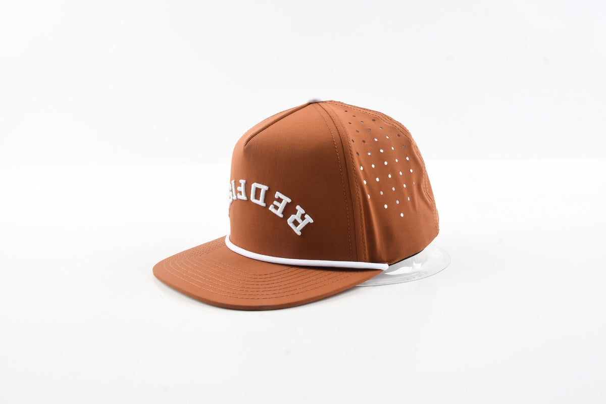 Angled side view of The Rojo rust brown performance fishing hat.