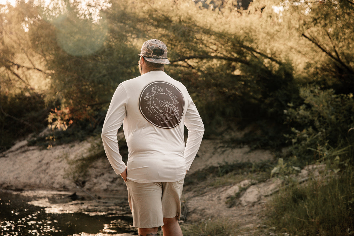 Person wearing Feathered Angler long sleeve fishing shirt outdoors