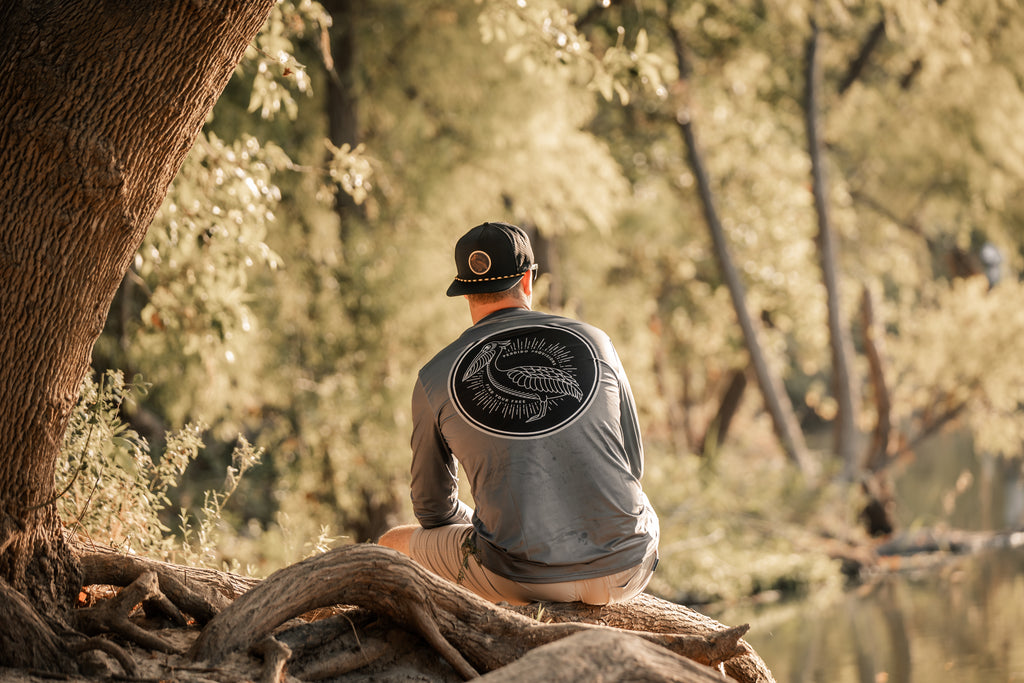 Performance long sleeve shirt in grey with with sublimated black pelican logo