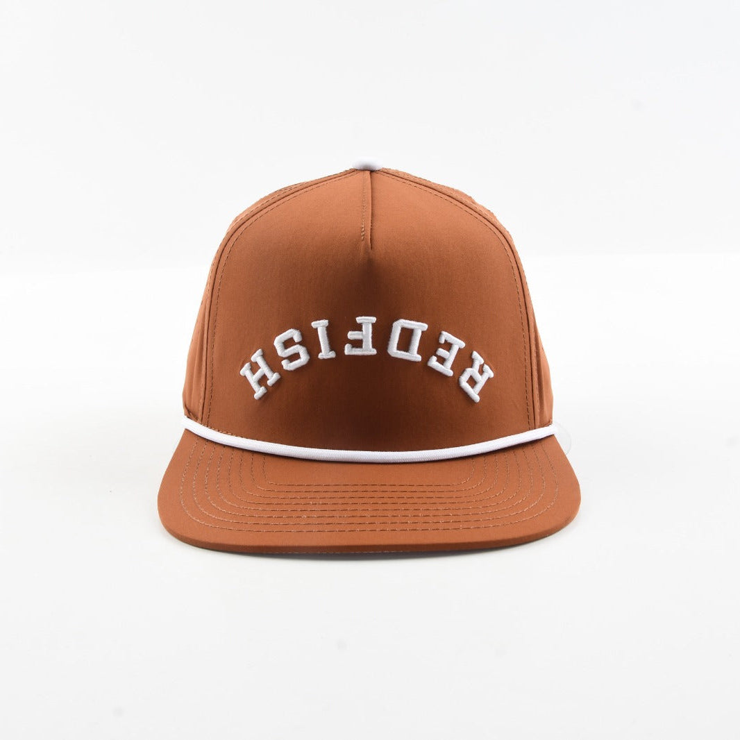 Front view of The Rojo rust brown snapback hat with white rope and arched Redfish lettering.